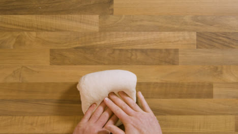 Top-View-Male-Kneading-a-Sticky-Dough-