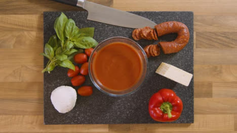 Top-View-Male-Placing-Bowl-of-Sauce-on-Worktop