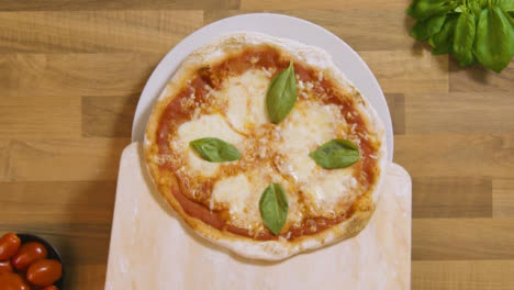 Top-View-Margarita-Pizza-on-Peel-Placed-on-Plate