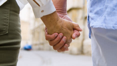 Extreme-Close-Up-of-Middle-Aged-Couple-Holding-Hands