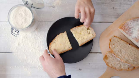 Two-View-Two-People-Take-a-Slice-of-Bread-from-Plate