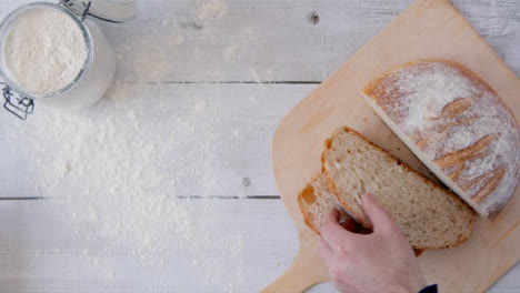Top-View-Hand-Picking-Up-Bread-Slice-from-Peel