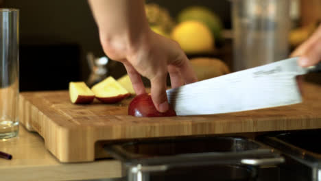 Close-Up-of-Female-Hands-Cutting-Some-Red-Apple