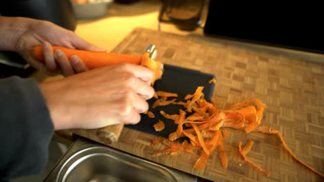Close-Up-of-Female-Hands-Peeling-a-Carrot