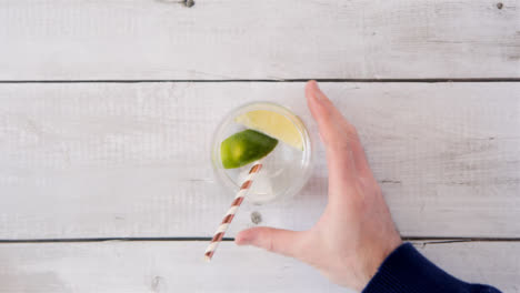 Top-view-Hand-Putting-Straw-in-a-Lemonade-Drink