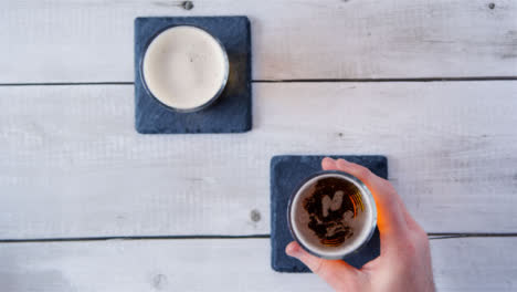 Top-View-Hand-Picks-Up-Glass-of-Beer