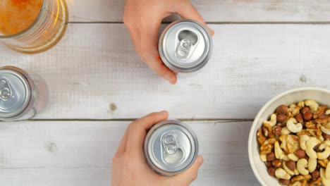 Top-View-Opening-Beer-Cans-and-Toasting-Drinks