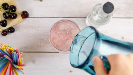 Top-View-Male-Hands-Adding-Flavoured-Drink-and-Cherry-to-Spirit