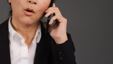 Middle-Aged-Businesswoman-Having-Heated-Phone-Call