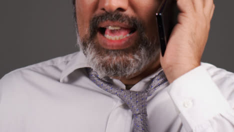Middle-Aged-Businessman-In-Turban-Having-a-Heated-Phone-Call
