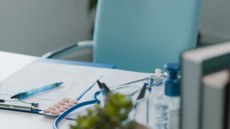 Empty-Doctors-Desk-with-Laptop-and-Stethoscope-