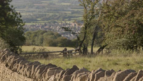 Pan-Up-From-Stone-Wall-to-Village-Below