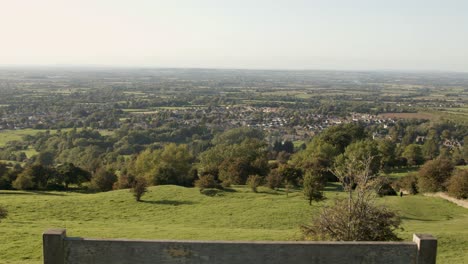 Reveal-of-Village-from-Wooden-Bench-on-Hill