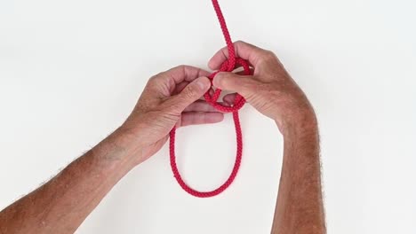 Red-thread-being-tied-into-a-knot