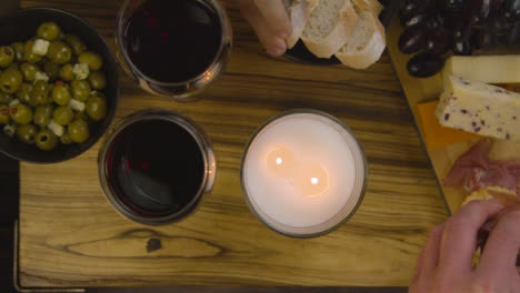 Two-People-Enjoying-an-Evening-Cheese-Board-Meal-with-Red-Wine