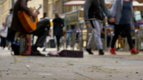 Low-Angle-Shot-of-Busker-On-Busy-Street-In-Oxford-02