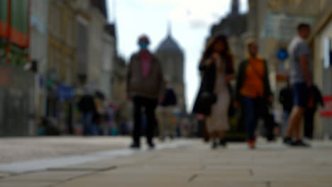 Defocused-Long-Shot-of-Pedestrians-Walking-Down-Cornmarket-Street-In-Oxford-England