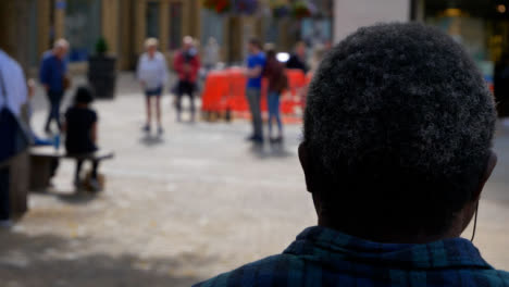Over-the-Shoulder-Shot-of-People-Walking-Through-Bonn-Square-In-Oxford-