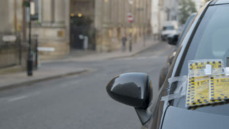 Sliding-Close-Up-Shot-of-Parking-Tickets-On-Car