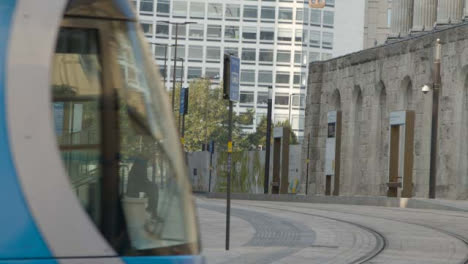 Two-People-Waiting-for-a-Tram-In-Birmingham