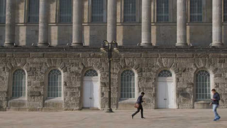 Wide-Shot-of-Two-People-Walking-Through-Victoria-Square