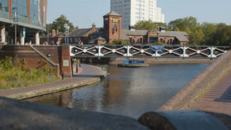 Panning-Shot-of-People-Walking-Over-Canal-Bridge-In-Birmingham-