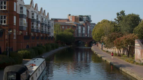 Panning-Shot-of-Runner-Alongside-Canal-In-Birmingham