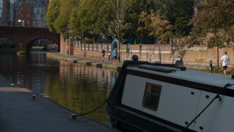 Tracking-Shot-of-People-Walking-Alongside-Canal-In-Birmingham
