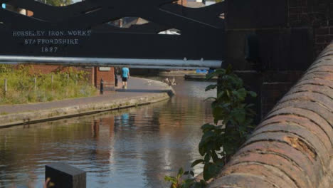 Panning-Shot-of-People-Walking-Alongside-Canal-In-Birmingham