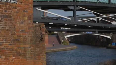 Panning-Shot-of-a-Runner-Alongside-a-Canal-In-Birmingham