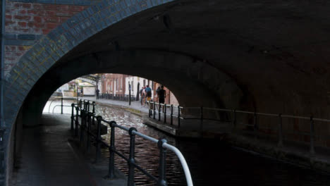 Tracking-Shot-of-People-Going-Through-Canalside-Tunnel-