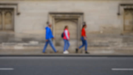 Defocused-Shot-of-People-and-Traffic-Travelling-Down-High-Street-In-Oxford-01-