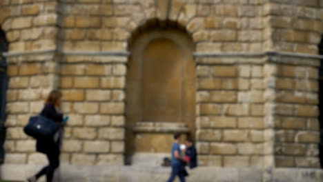 Defocused-Shot-of-Person-Eating-Lunch-In-Alcove-of-Oxfords-Radcliffe-Camera-Building