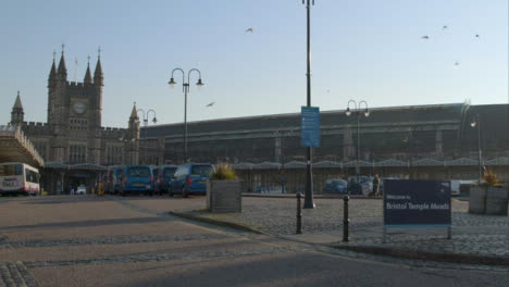 Wide-Shot-of-Birds-Flying-Around-Exterior-of-Bristol-Temple-Meads-Train-Station-