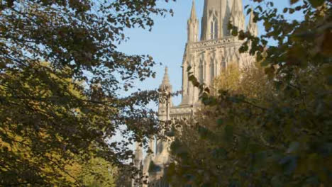 Tracking-Shot-of-St-Mary-Redcliffe-Church-Through-Some-Trees-In-Bristol-England
