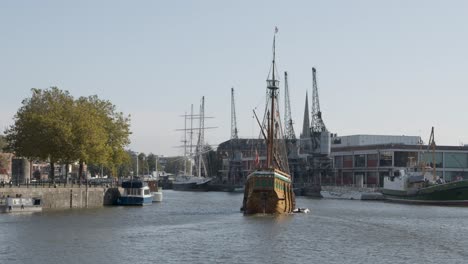 Wide-Shot-of-Imitation-Pirate-Ship-Sailing-Through-Bristol-Marina-In-Bristol-England