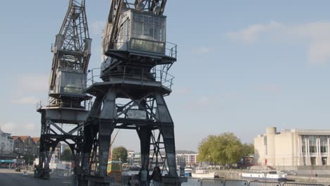 Tilting-Shot-of-Old-Disused-Cranes-at-Dock-In-Bristol-England