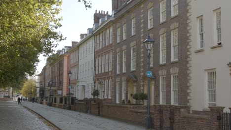 Sliding-Shot-of-Man-Walking-Down-Picturesque-Street-In-Bristol-England