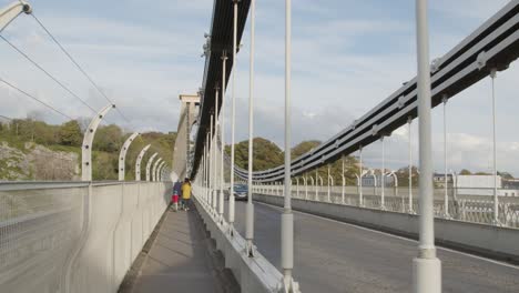 Tracking-Shot-of-Family-Walking-Across-Clifton-Suspension-Bridge-In-Bristol-England
