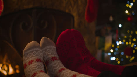 Close-Up-Shot-of-Couples-Feet-In-Front-of-Cosy-Burning-Fire