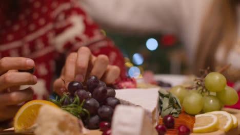 Extreme-Close-Up-Shot-of-Christmas-Table-Top-Food-Spread-with-Couple-In-Background-