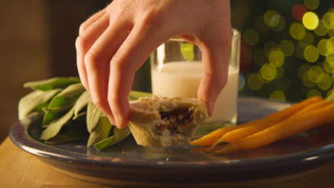 Sliding-Extreme-Close-Up-Shot-of-Hand-Taking-Away-Mince-Pie-and-Milk-From-Plate-