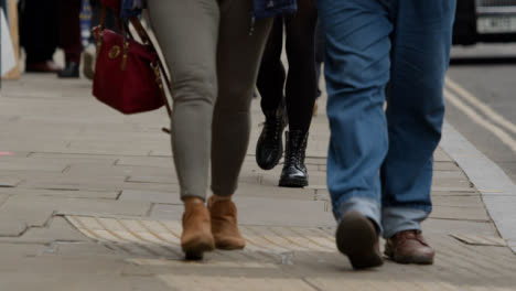 Long-Shot-of-Peoples-Legs-Walking-Down-Street-In-Oxford-England
