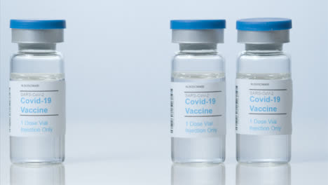 Sliding-Close-Up-Shot-of-Three-Vials-of-Covid-19-Vaccine-