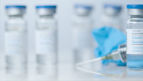 Sliding-Close-Up-Shot-of-Five-Vials-of-Covid-19-Vaccine-