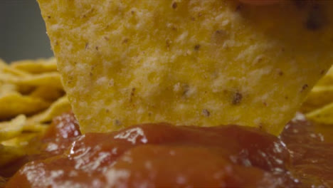 Sliding-Extreme-Close-Up-Shot-of-Nacho-Being-Dipped-Into-Sauce-