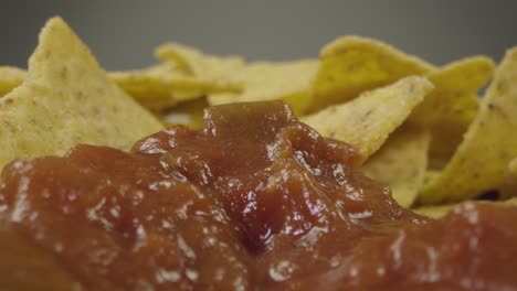 Sliding-Extreme-Close-Up-Shot-of-Nachos-Being-Dipped-Into-Sauce-