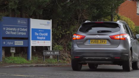 Wide-Shot-of-Cars-Driving-Past-Sign-for-Churchill-Hospital-