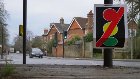 Wide-Angle-Shot-of-Ambulance-Passing-Traffic-Light-Outage-Sign