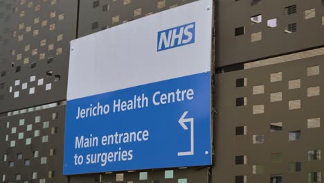 Handheld-Close-Up-Shot-of-the-Jericho-Health-Centre-Sign-